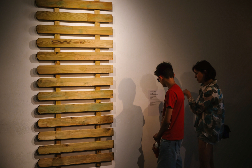 Viewers looking at The Angle of View in the gallery, 2024